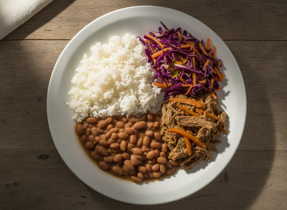 Prato feito brasileiro com arroz, feijão, carne desfiada e salada de repolho photo