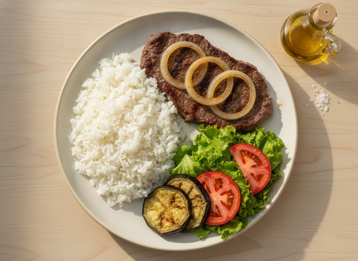 Prato feito brasileiro com bife acebolado, arroz, salada e berinjela photo